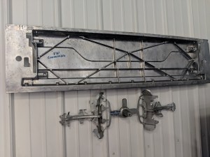 Photo of Die Cast header piece that Source Industries Machining in West Michigan machined a trim and form stamping die for.